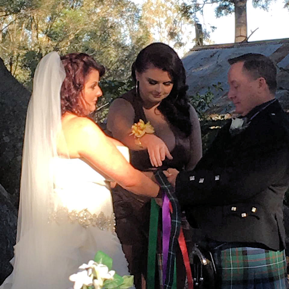 Handfasting using a tartan band plus coloured
                  ribbons